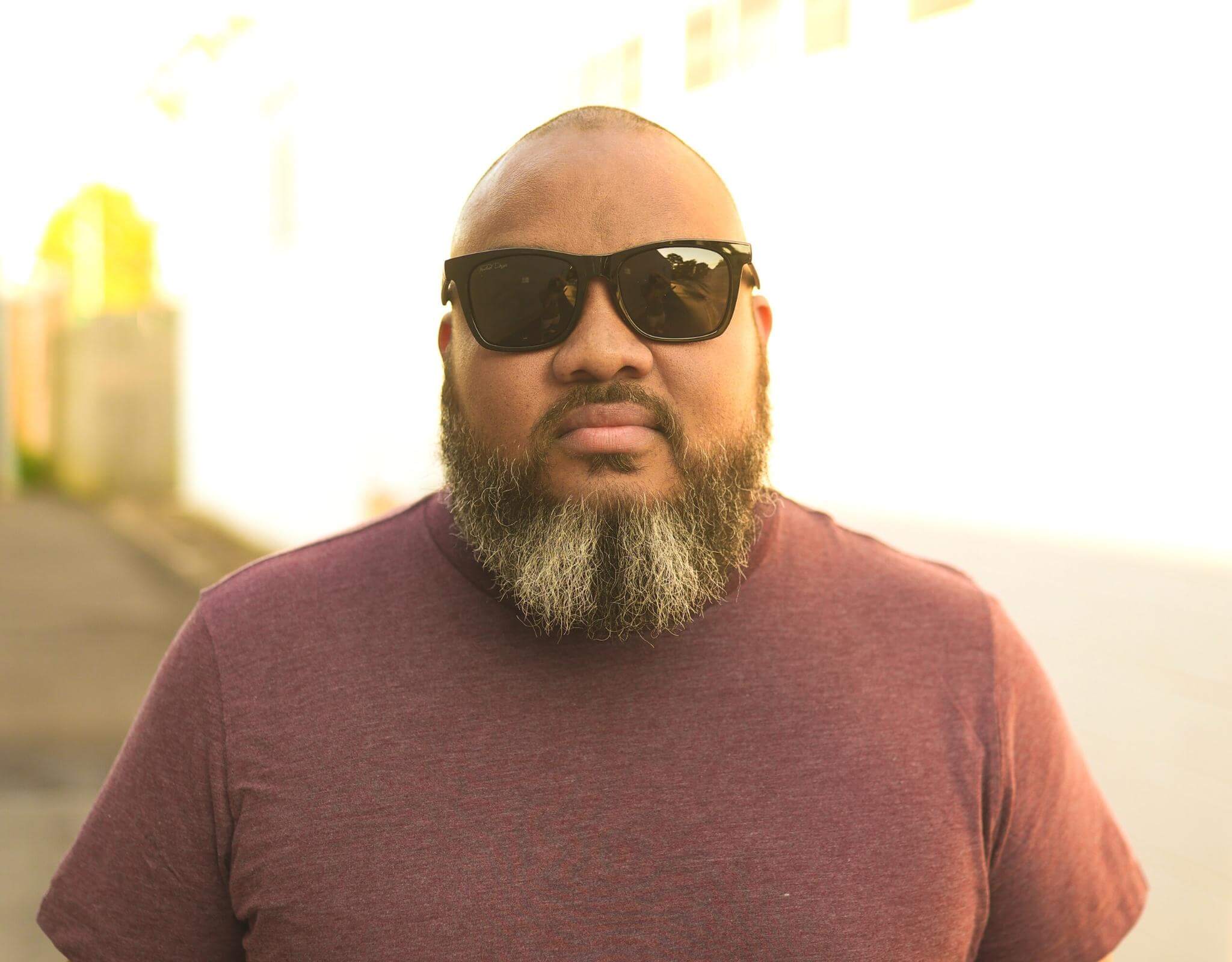 Model wearing Classic 165mm XXL polarised sunglasses for big heads in Black Gloss – secure, stylish fit for larger heads and wide faces.