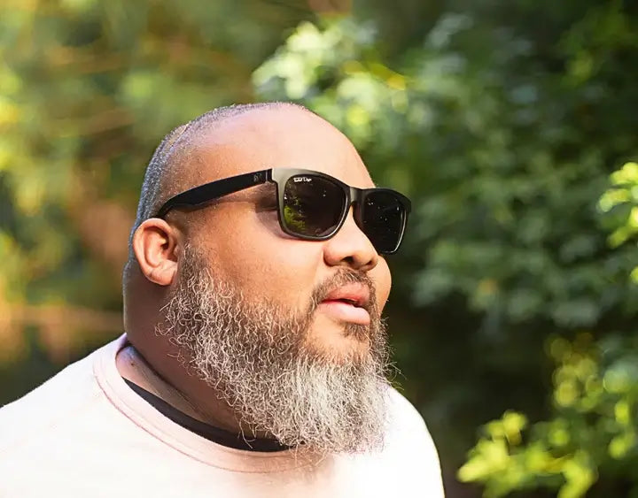 Model wearing Classic 165mm XXL blackout polarised sunglasses – extra wide sunglasses for large heads with a bold matte finish.