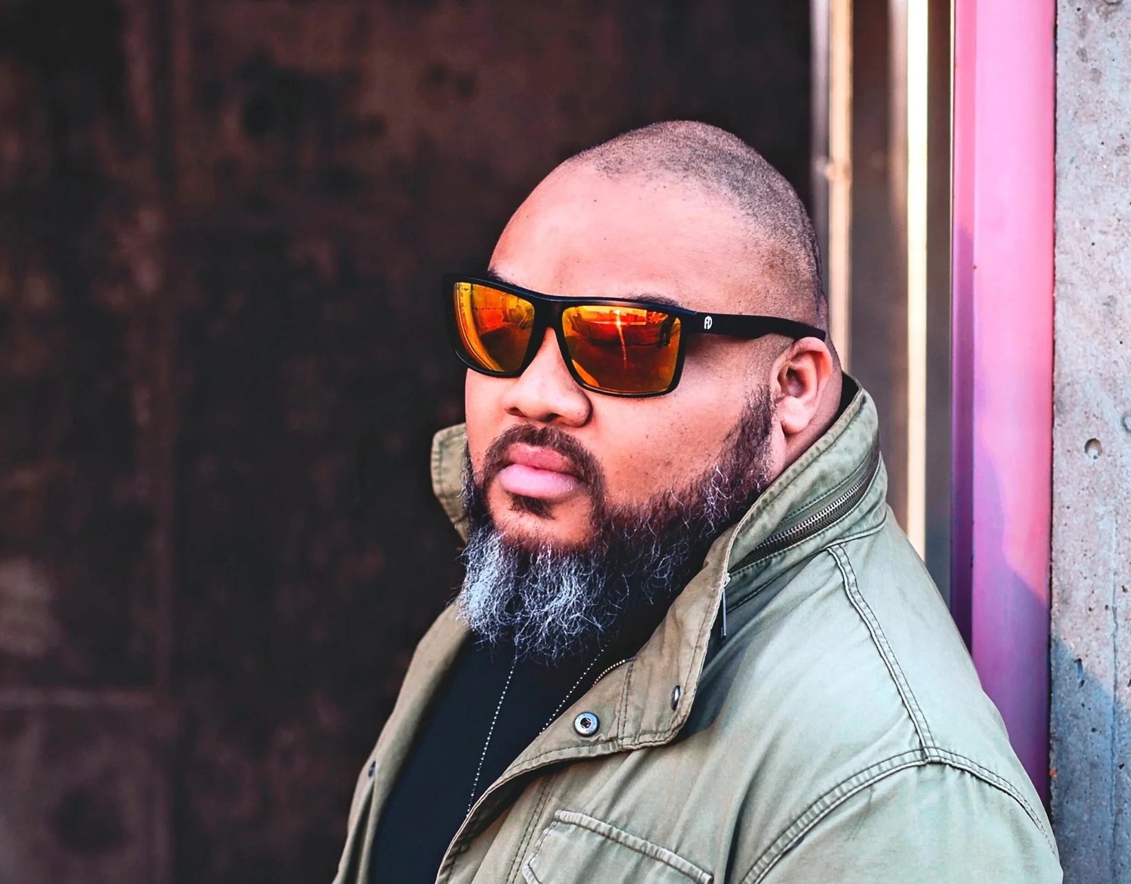 Model wearing Sport 165mm XXL polarised sport sunglasses in Black with red lava lenses – bold lens and secure fit for wide faces.