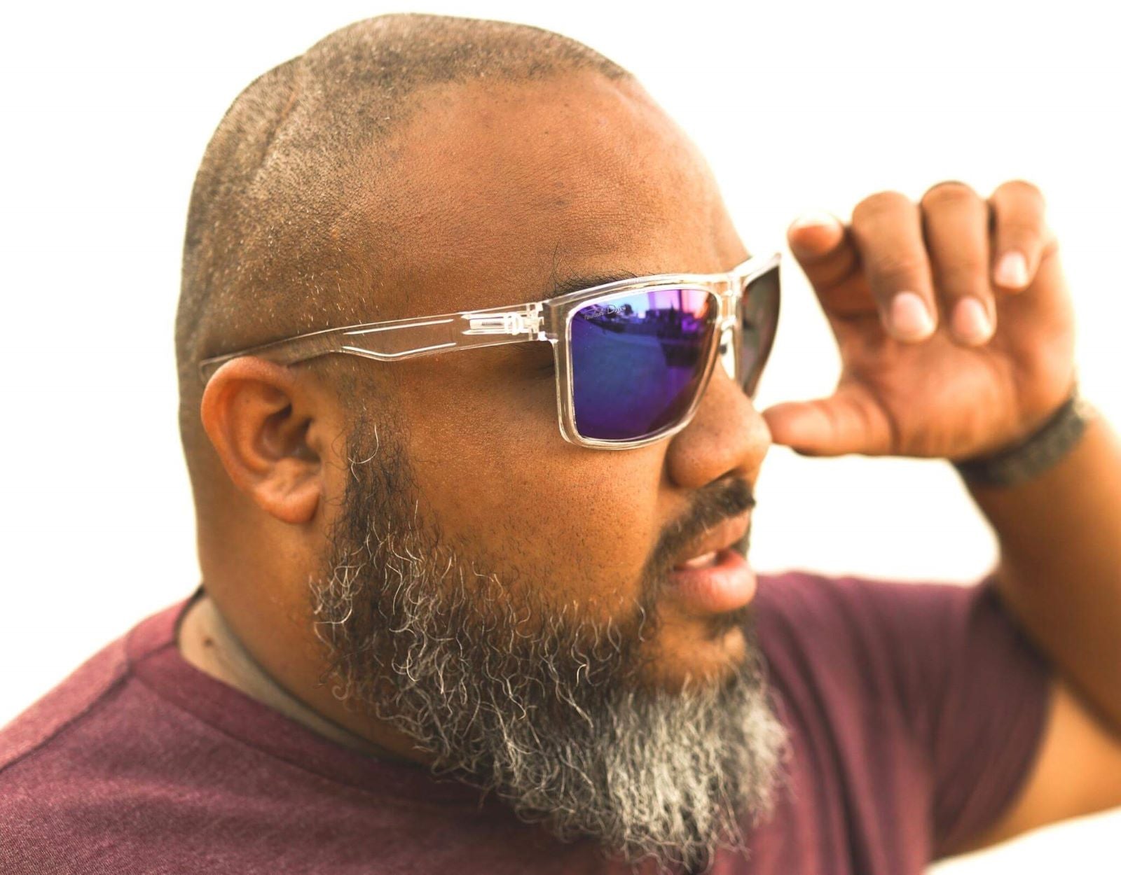 Model wearing Sport 165mm XXL extra wide sunglasses in Clear with green/blue polarised lenses – sporty, secure, and vibrant.