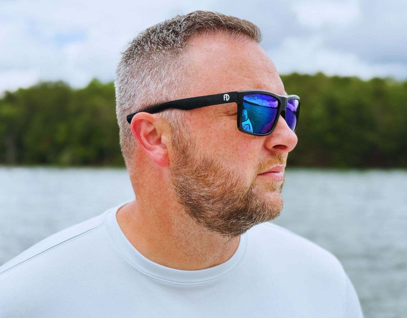 Model wearing Sport 155mm XL sunglasses in black with blue ice lenses – polarised sport shades designed for round faces and large heads.