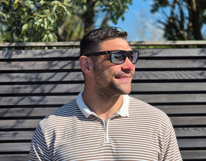 Model wearing Sport 155mm XL polarised sport sunglasses in Black with chrome lenses – bold mirrored style for round faces.