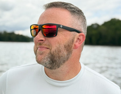 Model wearing Sport 155mm XL sunglasses in black with red lava lenses – polarised sport shades designed for round faces and large heads.