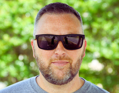 Model wearing Sport 155mm XL sunglasses in Black with Blackout logo – polarised sport shades designed for round faces and large heads.