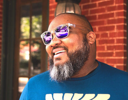 Model wearing Classic 165mm XXL large head sunglasses in Clear with purple polarised lenses – wide fit with bold, colourful flair.