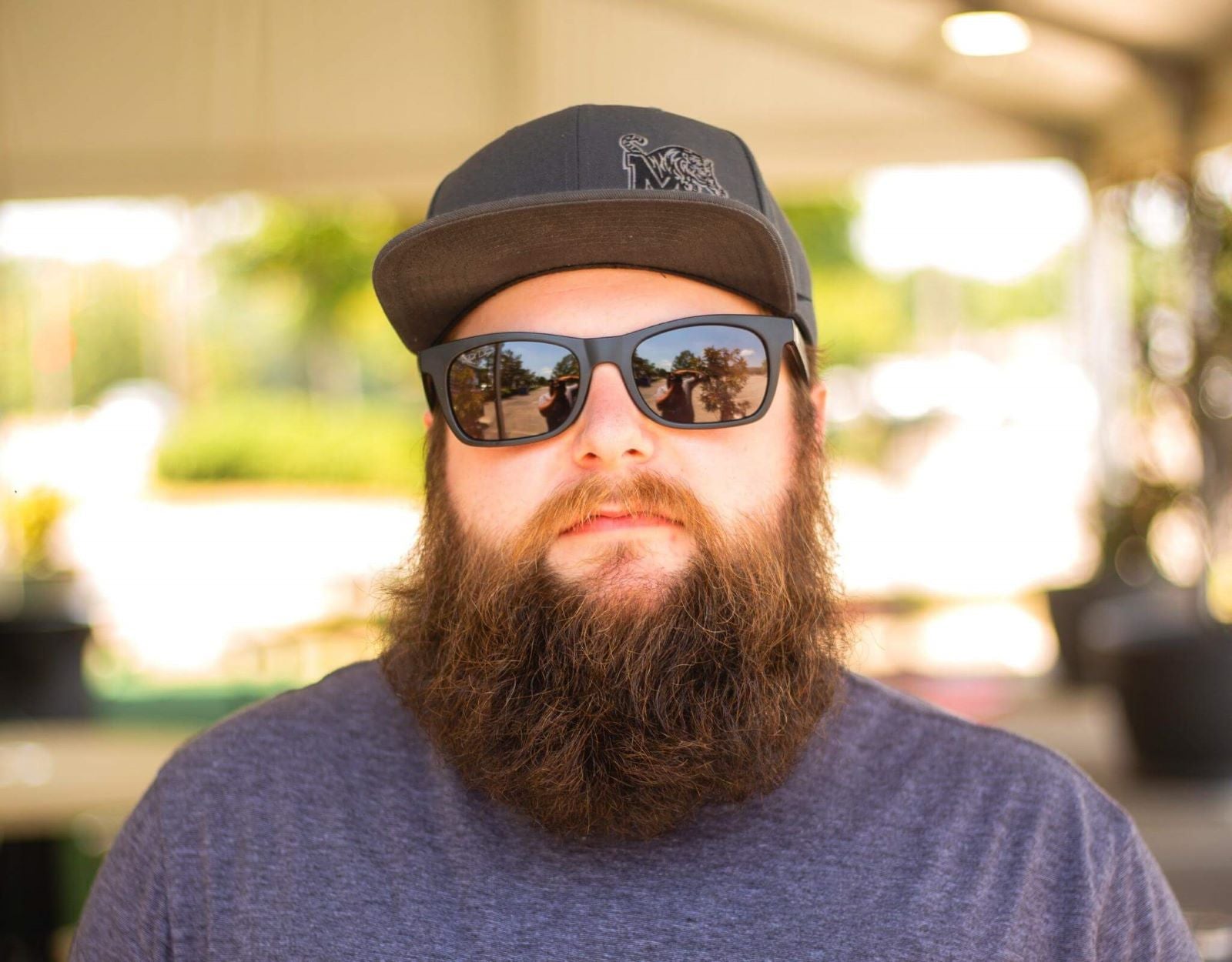 Model wearing The Gent 165mm XXL blackout polarised sunglasses – bold, ultra-wide sunglasses for guys with wide faces.