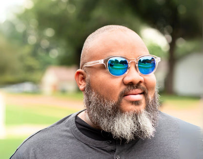 Model wearing The Scholar 165mm XXL sunglasses for wide faces in Clear – modern, oversized style with mirrored blue lenses.