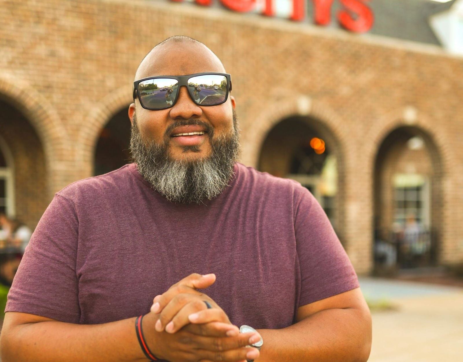 Model wearing Sport 165mm XXL big head sunglasses in Black with chrome polarised lenses – secure and ready for action.