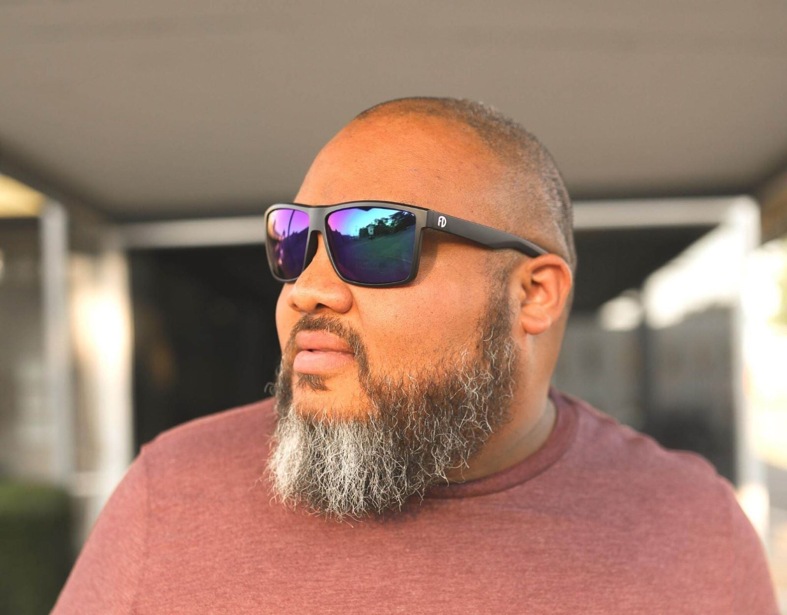 Model wearing Sport 165mm XXL extra wide sport sunglasses in Black with green-blue lenses – athletic, secure, and stylish.