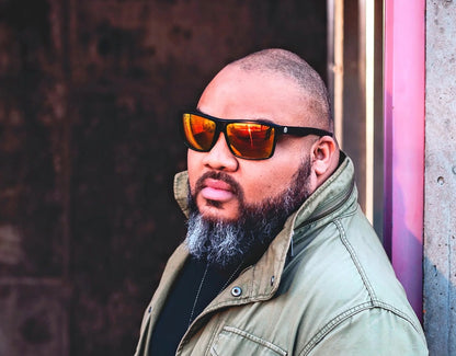 Model wearing Sport 165mm XXL polarised sport sunglasses in Black with red lava lenses – bold lens and secure fit for wide faces.